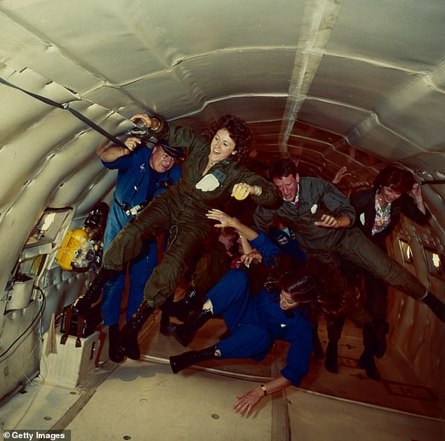 Members of the crew experiencing weightlessness ahead of the launch in a research craft