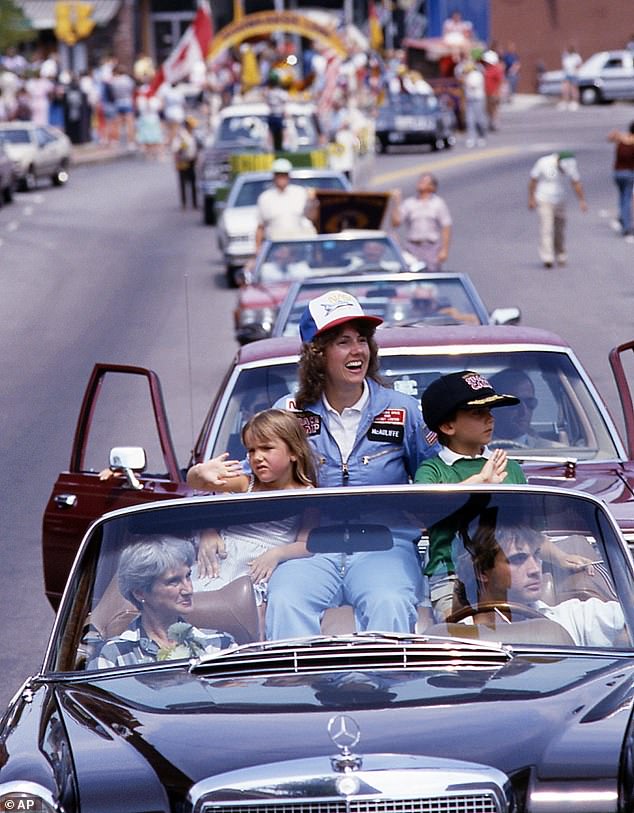 Christa riding along with her children Caroline and Scott during a parade to celebrate the space shuttle