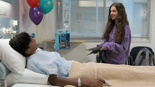 Nell sits over Dex's hospital bed in Neighbours