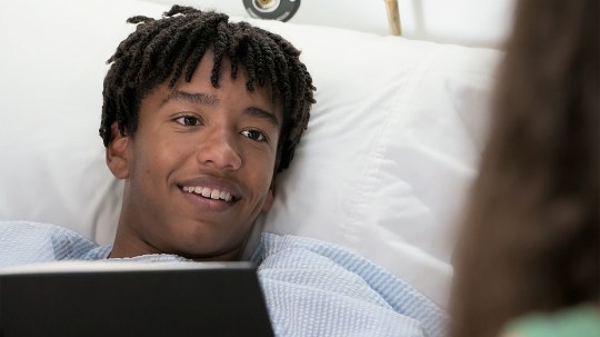 Dex looks delighted in his hospital bed in Neighbours